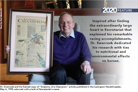 Dr. Thomas Swerczek holding a framed Lexington Herald-Leader Anatomy of a Champion feature